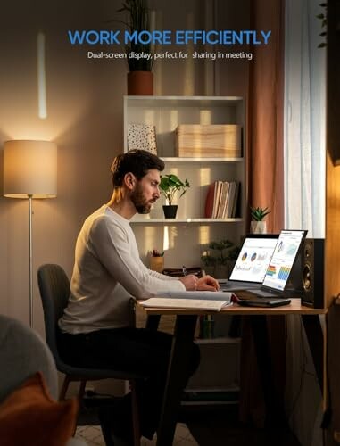 Man working at desk with dual screens in a home office.