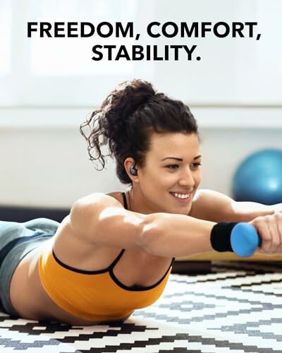 Woman exercising with dumbbells indoors.